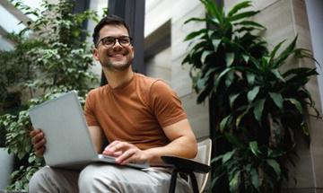 Man sitting on porch with his laptop